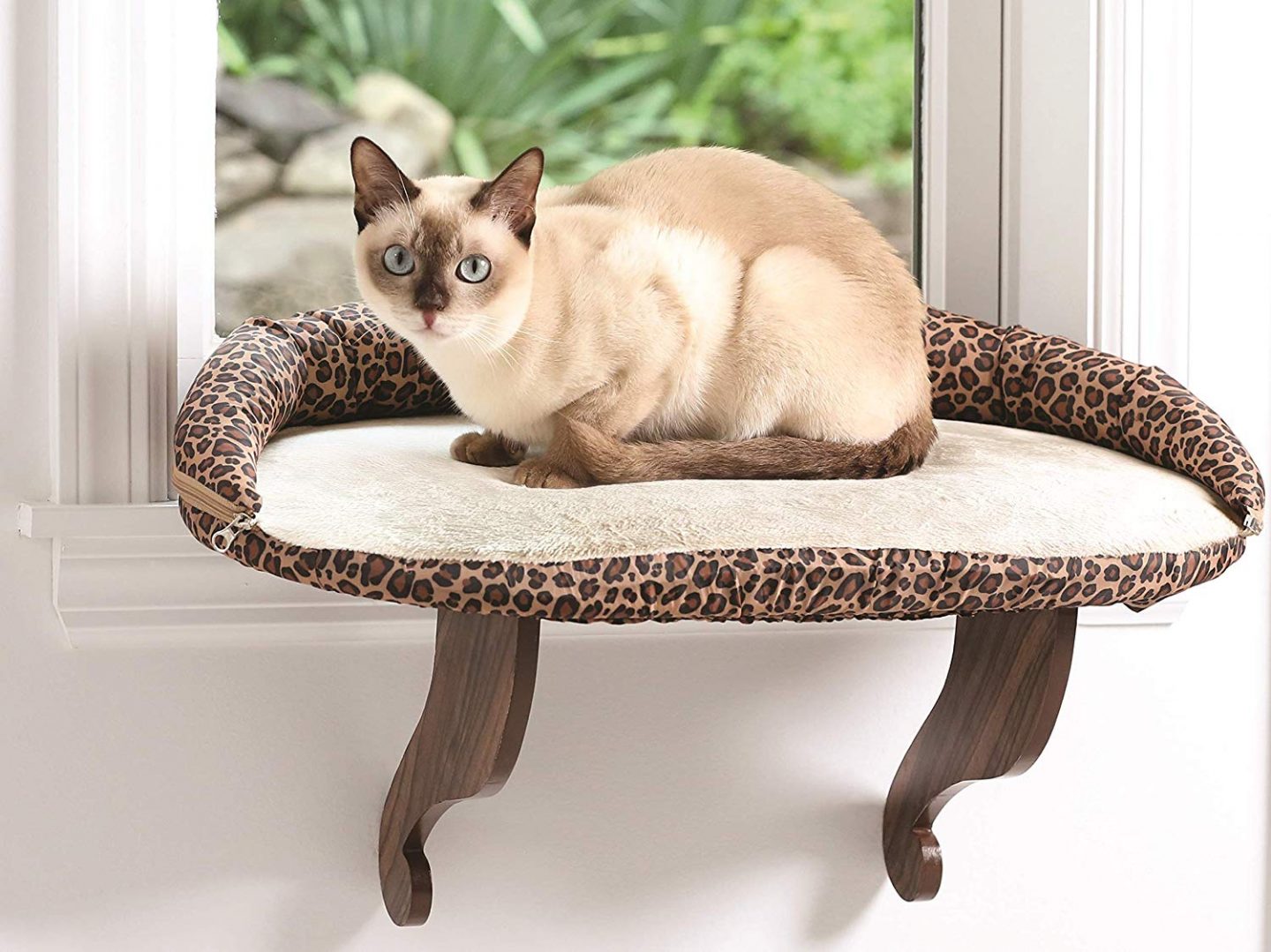 A leopard print window mounted cat bed isn't something you see everyday.  But it's a space saver as well as a statement piece.  Window sill cat beds can really save your floorspace in an apartment!