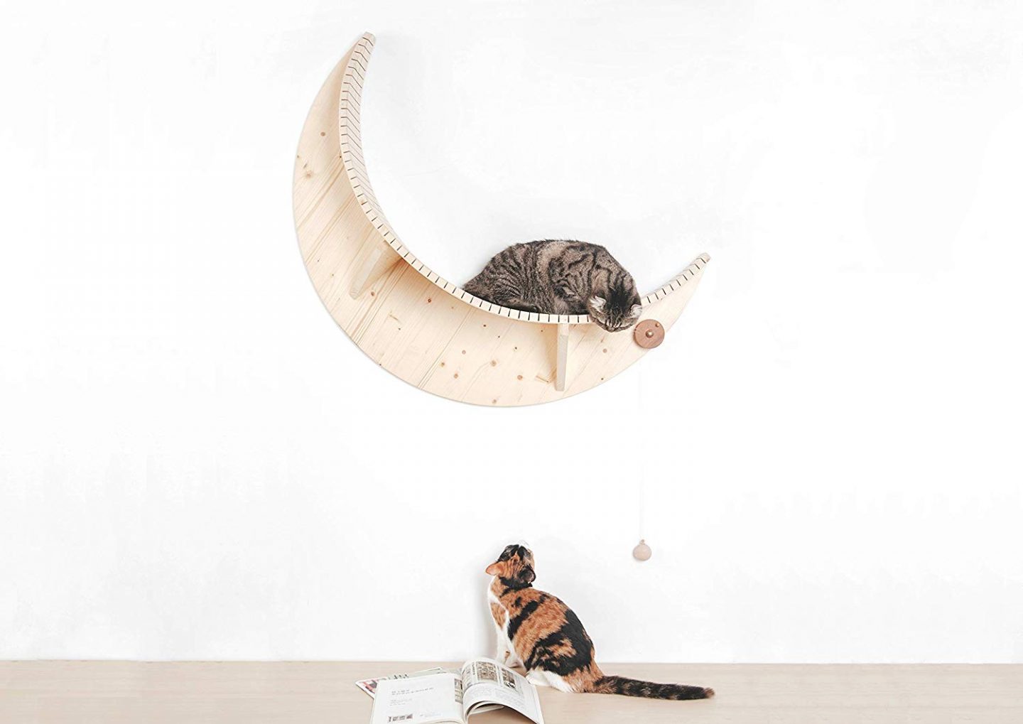 The Luna cat perch is a beautiful space themed cat perch in the shape of a crescent moon, made from solid wood and sure to go well with modern, contemporary or minimalist decor.